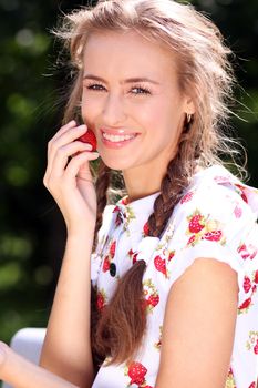 Portrait of the beautiful girl with a strawberry