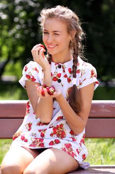Portrait of the beautiful girl with a strawberry