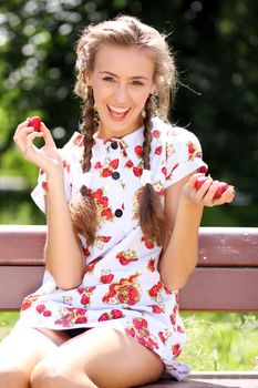 Portrait of the beautiful girl with a strawberry
