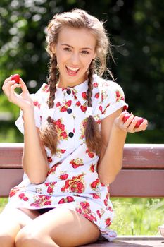 Portrait of the beautiful girl with a strawberry