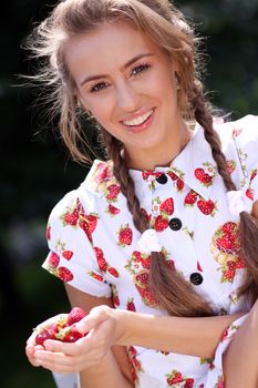 Portrait of the beautiful girl with a strawberry