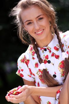 Portrait of the beautiful girl with a strawberry