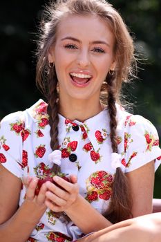 Portrait of the beautiful girl with a strawberry