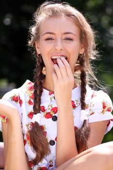Portrait of the beautiful girl with a strawberry