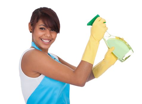 Cheerful young lady spraying cleaner liquid. Isolated on white