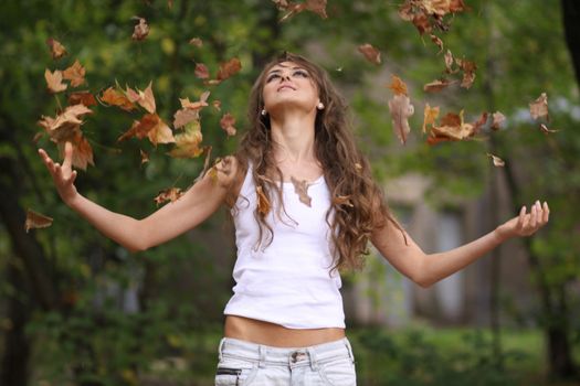 Beautiful young woman in autumn park