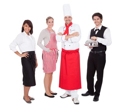 Group of restaurant chef and waiters. Isolated on white