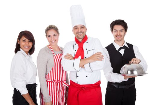 Group of restaurant chef and waiters. Isolated on white