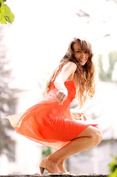 Portrait in full growth, attractive young woman in red dress