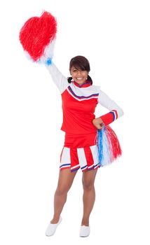 Smiling beautiful cheerleader with pompoms. Isolated on white