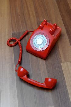 A vintage telephone isolated on a wooden floor