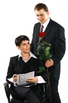 The business girl works and director tries to present it a flower