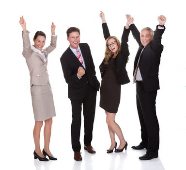 Four excited diverse professional businesspeople celebrating a success laughing and raising their arms in the air isolated on white