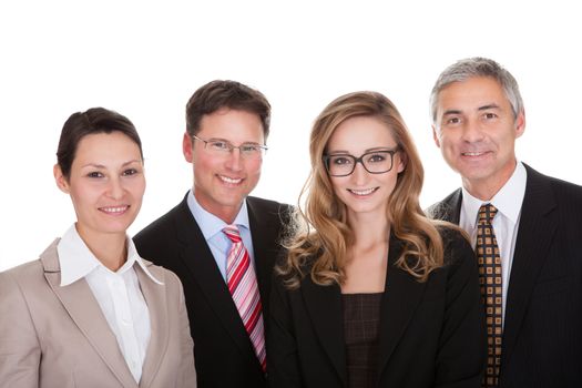 Smiling group of stylish business professionals standing in a row with their arms folded looking at the camera isolated on white