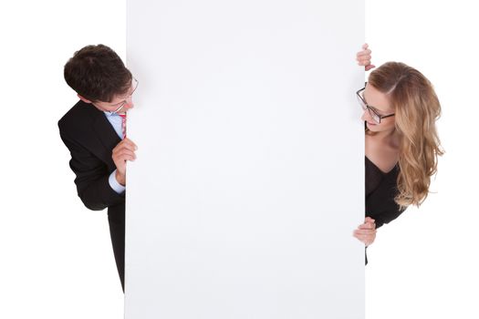 Smiling professional man and woman wearing glasses holding up a blank white sign for your text or advertisement isolated on white