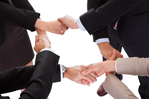 Cropped overhead view of a diverse group of businesspeople linking hands in a team
