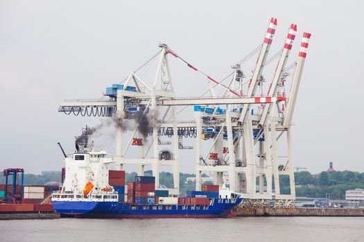 Huge container ship fully loaded in port terminal