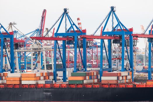 Huge container ship fully loaded in port terminal