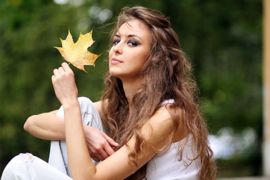 Beautiful young woman in autumn park