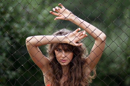 Closeup portrait through an iron lattice