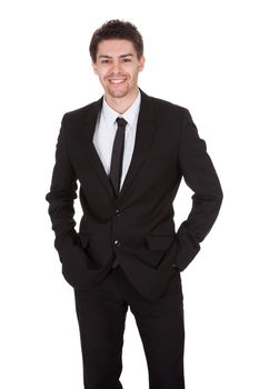 Full length studio portrait on white of a smiling confident young businessman standing with folded arms