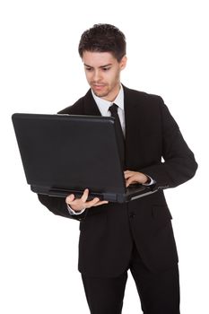 Businessman working on laptop. Isolated on white