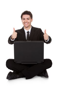 Joyful businessman with laptop rejoicing. Isolated on white