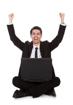 Joyful businessman with laptop rejoicing. Isolated on white