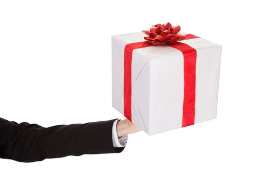 Arm of a man wearing a suit holding out a decorative gift isolated on white