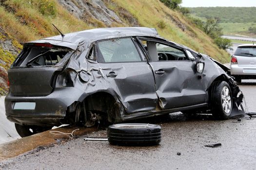 Modern automobile stuck on the road after rolling in the wet weather