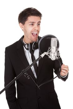 Young singer and microphone. Isolated on white