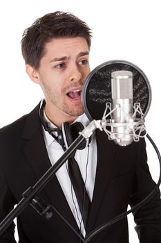 Young singer and microphone. Isolated on white