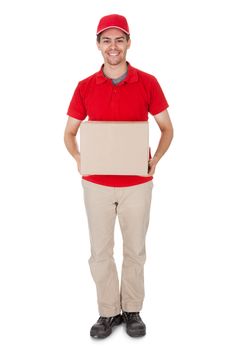 Smiling male courier in a red shirt and cap delivering a parcel in a brown cardboard box