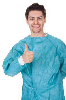 Smiling confident young surgeon wearing a gown and stethoscope standing with his arms crossed isolated on white