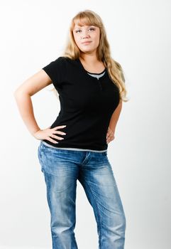 Young woman in jeans with long hair standing