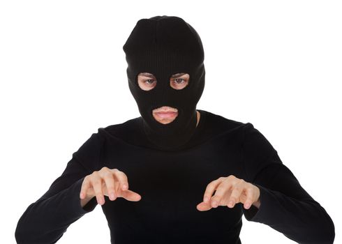 Thief wearing a balaclava dressed in blacked moving stealthily. Isolated on white