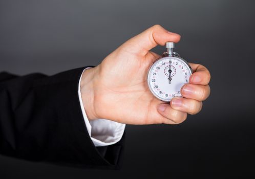 Business man holding stop watch in his hand