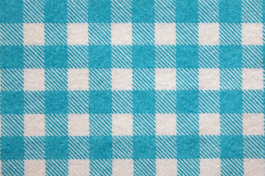 Material into blue grid, a textile background.
