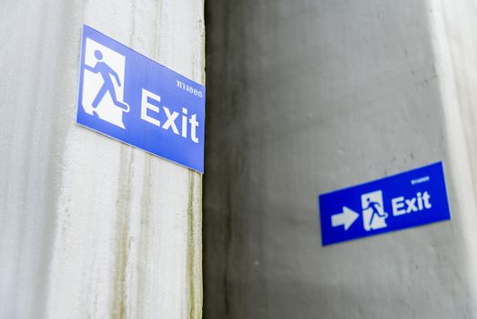 Blue exit sign on white wall2