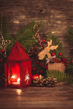 Red christmas candlestick over holiday decorations on the table