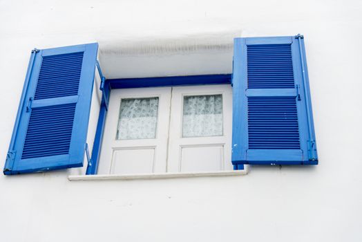 Opened blue window on white wall3
