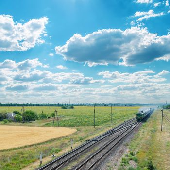 old train on railroad under cloudy sky