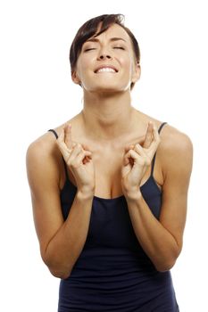 Young woman with crossed fingers looking hopeful