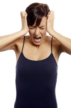 Young woman holding her head and screaming