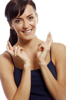 Young woman with crossed fingers looking hopeful