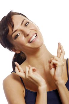 Young woman with crossed fingers looking hopeful