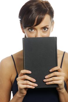 Young woman holding a black book over her face