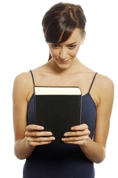 Woman holding a book expressing anticipation.
