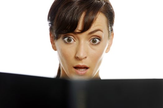 Young woman reading a scary book