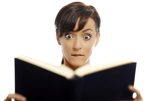 Young woman reading a scary book